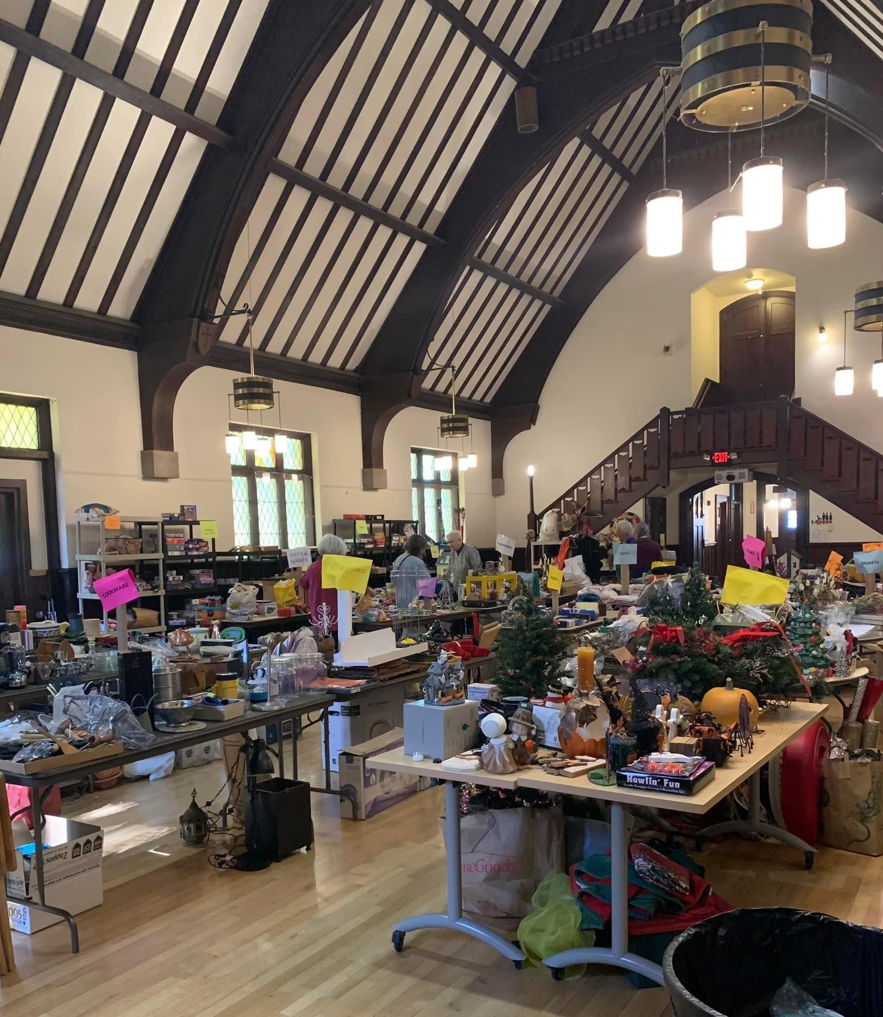 In the Parish Hall, folding tables and temporary shelves are fully laden with items for the yard sale.