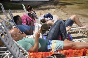 Campers lounge on beach chairs at Sandy Island.