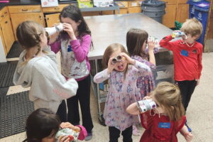 Parents Night Out kids looking through binoculars they made to look for leprechauns