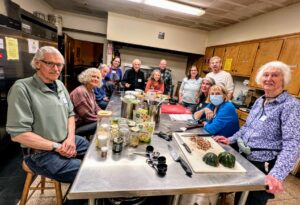 PBEC team of people learning how to cook plant-based meals in FUUSN's kitchen